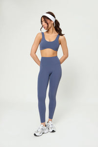 Базові легінси темно-синього кольору worn by woman with high waist and smooth fit for sport and casual wear