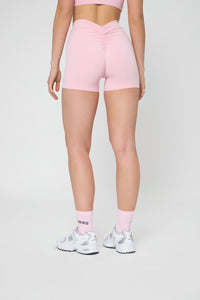 Шорти V push-up кольору рожевої пудри, ззаду, вкорочені, з зібраною деталлю на посадці, приталені